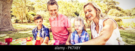 Happy family having meal in park Stock Photo