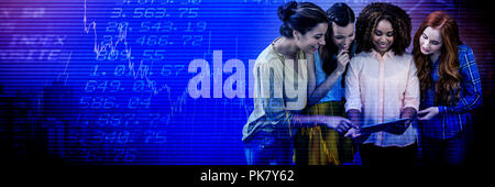 Composite image of smiling businesswomen discussing over tablet Stock Photo