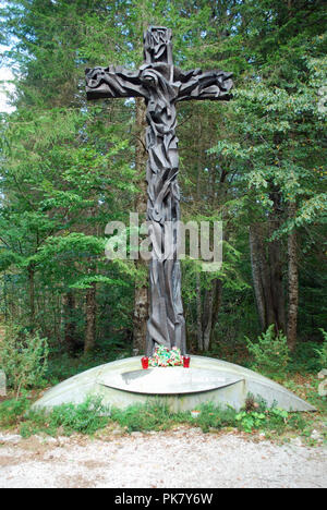 A carved wooden memorial cross dedicated to those executed by Tito's ...