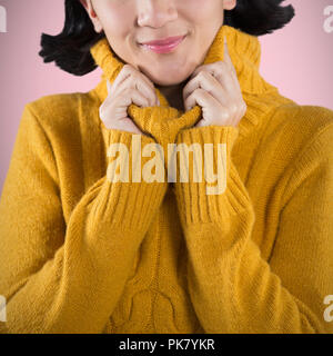 Composite image of woman in winter clothing posing against white background Stock Photo