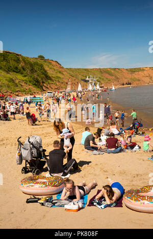 UK, England, Yorkshire, Filey, visitors on beach near Coble Landing Stock Photo