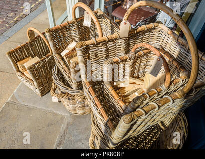 Wicker log baskets for sale outside a shop. Stock Photo
