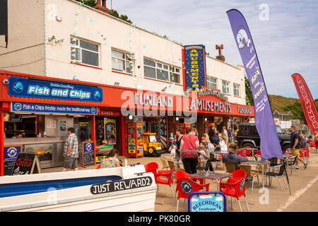 Seafront shops and amusement arcades with sea and beach in the ...