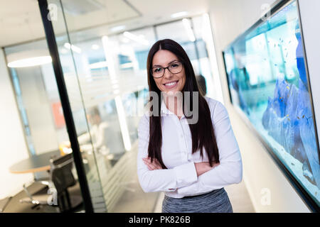 Portrait of young beautiful businesswoman in office Stock Photo