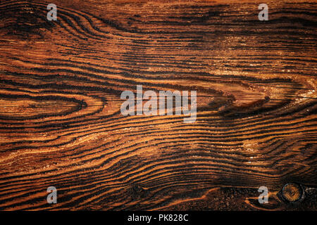 Closeup of an old rich wood grain texture background with knots. Stock Photo