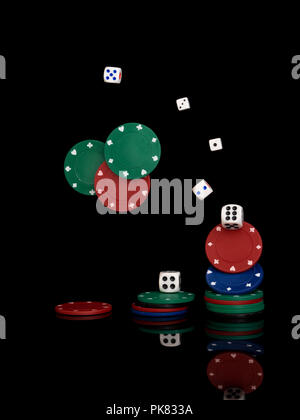 Gambling. Dice and plastic chips isolated on black background. Stock Photo