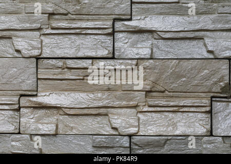 Background of a wall stacked with stone blocks Stock Photo