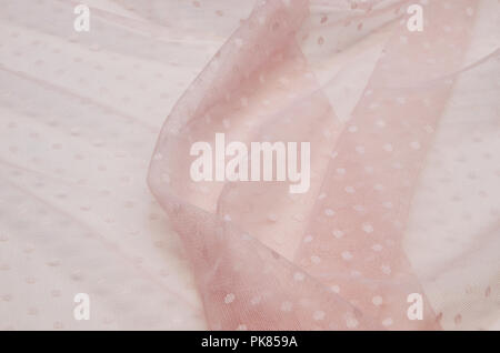 Polyamide fabric with polka dots light pink with elastane. Stock Photo