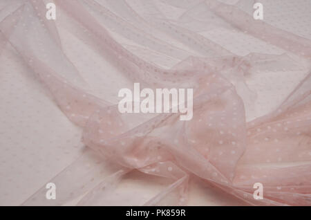 Polyamide fabric with polka dots light pink with elastane. Stock Photo