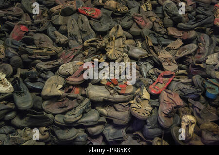 Auschwitz, Poland - February 16, 2018: Pile of shoes from the people who were killed by nazis in Auschwitz Birkenau Concentration Camp Stock Photo