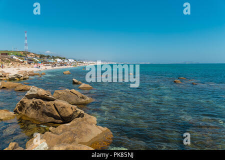 Fnideq, Morocco - September 6th 2018 : high angle view of people resting in Ristinga beach Stock Photo