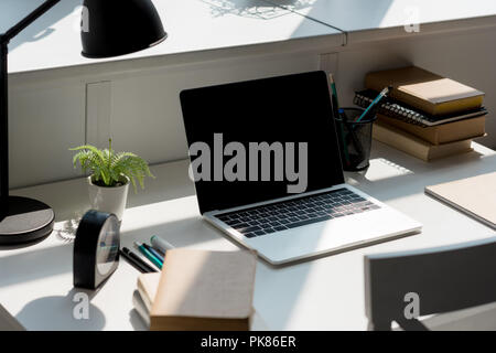 close-up shot of modern workplace with laptop at home Stock Photo