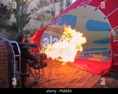 Hot air balloon in Goreme Cappadocia being filled with hot air using a big flame propane burner Stock Photo