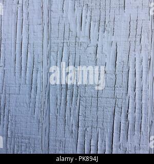 White cracked paint on wooden surface, weathered paint. Stock Photo