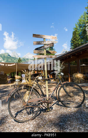 Rusty Bicycle and Wooden Photo Booth Direction Sign at Shabby Chic Wedding Stock Photo