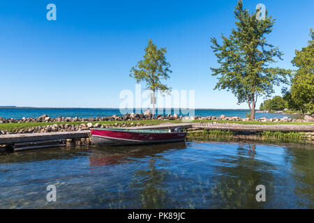 Lake Manitou shoreline fishing boat moored at dock on Manitoulin Island Stock Photo