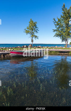 Lake Manitou shoreline fishing boat moored at dock on Manitoulin Island Stock Photo