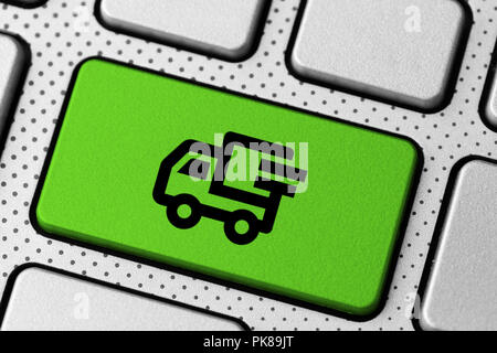 online shopping and delivery concept. laptop keyboard button with truck icon Stock Photo