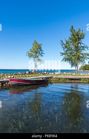 Lake Manitou shoreline fishing boat moored at dock on Manitoulin Island Stock Photo