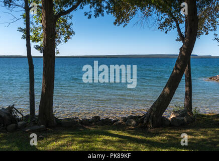 Lake Manitou shoreline landscape with cedar trees and rocks on Manitoulin Island Stock Photo