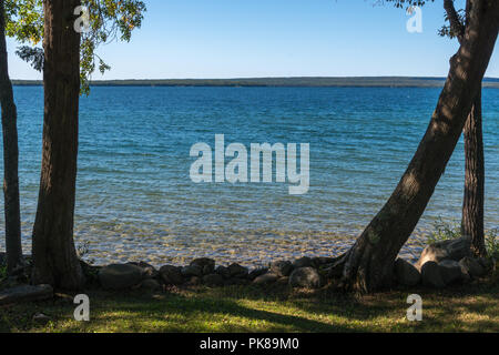 Lake Manitou shoreline landscape with cedar trees and rocks on Manitoulin Island Stock Photo