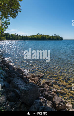 Lake Manitou shoreline landscape with cedar trees and rocks on Manitoulin Island Stock Photo