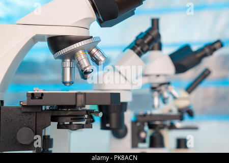 Four microscopes of different designs in the laboratory Stock Photo