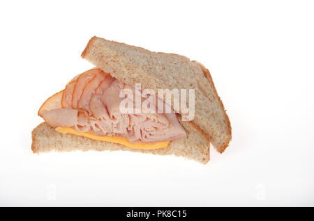 Half a smoked turkey and cheese sandwich on whole wheat bread Stock Photo