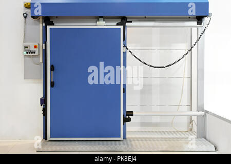 Automated insulated blue door at reefer refrigerator Stock Photo