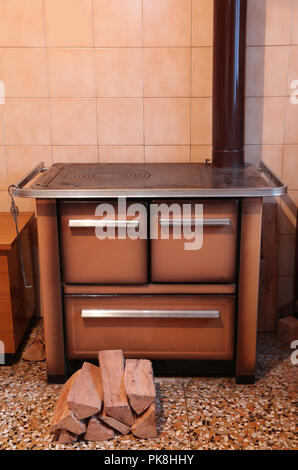 old wood-burning stove inside the kitchen of the home in mountain Stock Photo