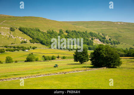 UK, Yorkshire, Wharfedale, Hubberholme, agriculture, farmer mowing hay meadow in sunny summer weather Stock Photo