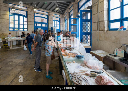 A saleswoman serves a customer at the fish market in the market hall of Mali Lošinj, island of Lošinj, Kvarner bay, Croatia Stock Photo