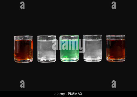 Multicolored transparent cocktails, a set of shots in one row, five servings. Side view Isolated black background. Drink for the menu restaurant, bar, Stock Photo