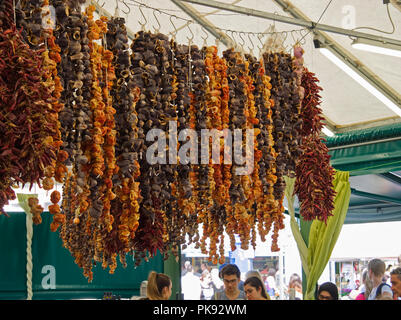 Dried chilli peppers on a fruit and vegetable stall in the Viktualienmarkt, a daily food market and a square in the centre of Munich, Germany. Stock Photo