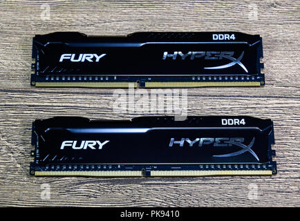 RAM Kingston Fury on a wooden table. RAM with a radiator. Overclocker RAM. Stock Photo