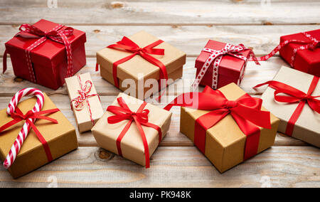 Christmas time. Gift boxes with red ribbons on wooden background Stock Photo