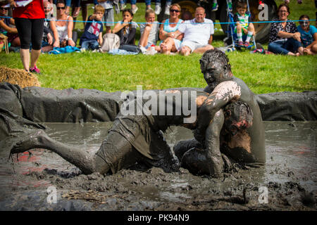 Two men mud wrestling at a mud fighting competition at The LowLand
