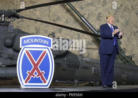 President Donald J. Trump applauds 10th Mountain Division (LI) Soldiers at Fort Drum, New York, on August 13, August 13, 2018. President Trump was visiting the U.S. Army post to sign the National Defense Authorization Act of 2019, which raises Soldier pay by 2.6 percent recognizing the service and sacrifice they make on behalf of our Nation. (U.S. Army photo by Sgt. Thomas Scaggs) 180813-A-TZ475-851. () Stock Photo