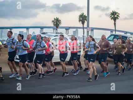 180813-N-NT795-740 CORONADO, Calif. (August 13, 2018) Chief Yeoman Select Kassiana Earp, assigned to Coastal Riverine Group (CRG) 1, leads the chief petty officer (CPO) and CPO selectees during physical training as part of CPO initiation onboard Naval Amphibious Base Coronado, August 13, 2018. CPO initiation is a professional education and training environment that starts when the announcement message is released, and time-honored tradition focused on the team/individuals as leaders of integrity, accountability, initiative and toughness. (U.S. Navy photo by Chief Boatswain's Mate Nelson Doroma Stock Photo