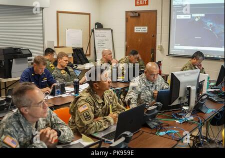 Service members with Joint Task Force 5-0 receive a daily commander's update brief, August 25, 2018 at the Hawaii Army National Guard Center at Diamond Head, Honolulu Hawaii, August 24, 2018. JTF 5-0 is a joint task force led by a dual status commander that is established to respond to the effects of Hurricane Lane on the state of Hawaii. The members of the task force remain committed to monitoring the effects and incidents across the state of Hawaii to respond to any requests made by Local and state authorities through FEMA. () Stock Photo