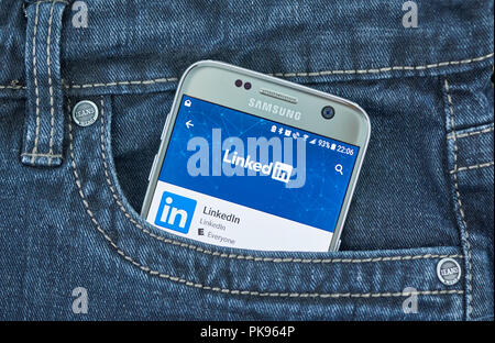 MONTREAL, CANADA - AUGUST 10, 2018: Linkedin app on a cellphone screen in a jeans pocket. LinkedIn is a social networking site designed specifically f Stock Photo