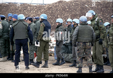 8th March 1993 During the Siege of Sarajevo: a group of United Nations soldiers and police near the terminal building at Sarajevo Airport. Several nationalities are evident: French, Norwegian and Canadian. Stock Photo