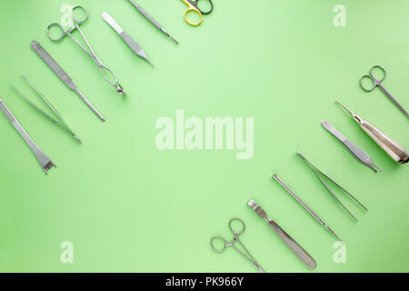 Medical equipments including surgical instruments on a green background. top view, copy spase Stock Photo