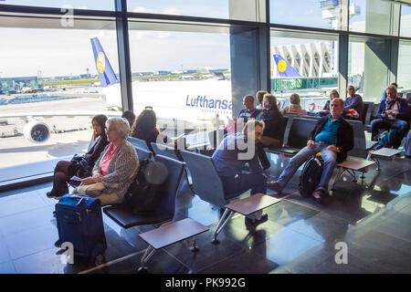 Frankfurt, Germany - April 28, 2018: passengers sitting and waiting for departure inside of Frankfurt Pearson Airport at Frankfurt, Germany on April 28, 2018 Stock Photo