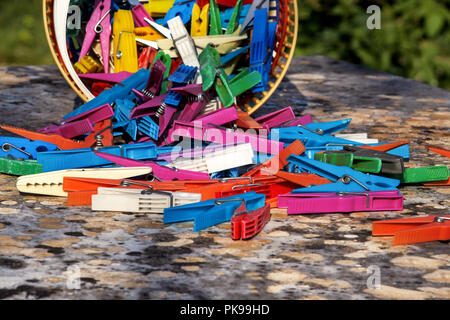 Clothespins. Colorful plastic clothespins, stand on the table. Cloth clothespins. Stock Photo