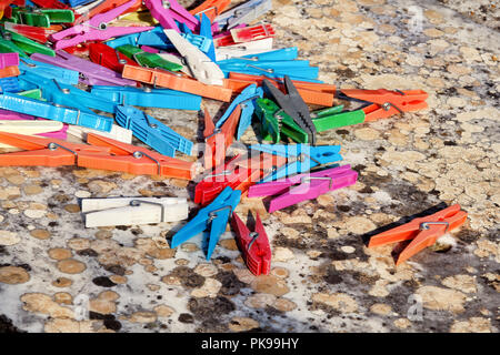 Clothespins. Colorful plastic clothespins, stand on the table. Cloth clothespins. Stock Photo
