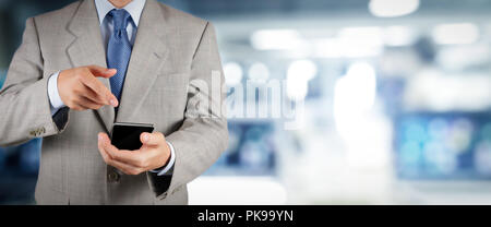 businessman workimg on VR blank wide touch screen computer on office blur background. Stock Photo