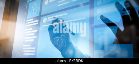 Web page browser of Social media Page VR Interface on the laptop computer.Businessman hand pressing an imaginary button on virtual screen Stock Photo