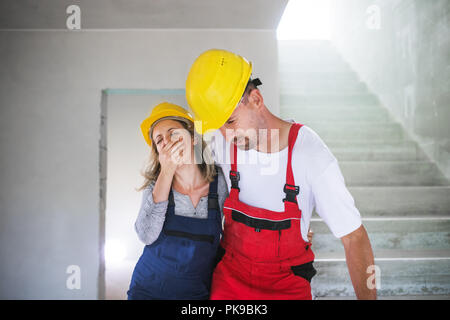 Woman and man workers suffocating at the construction site. Stock Photo