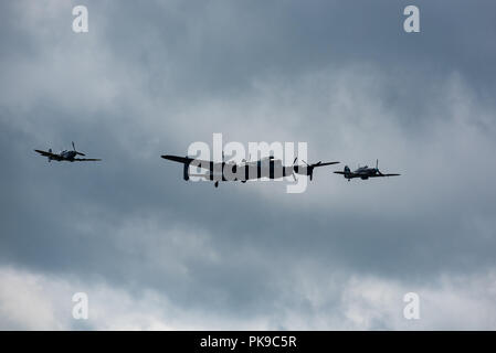 An Avro Lancaster accompanied by an escort of a Hurricane and a Spitfire Stock Photo